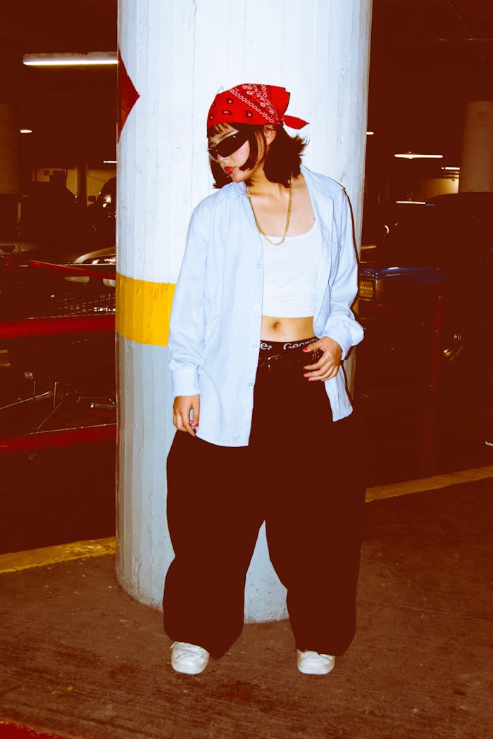 services-01 Casual streetwear style featuring oversized pants and a red bandana in an urban setting.